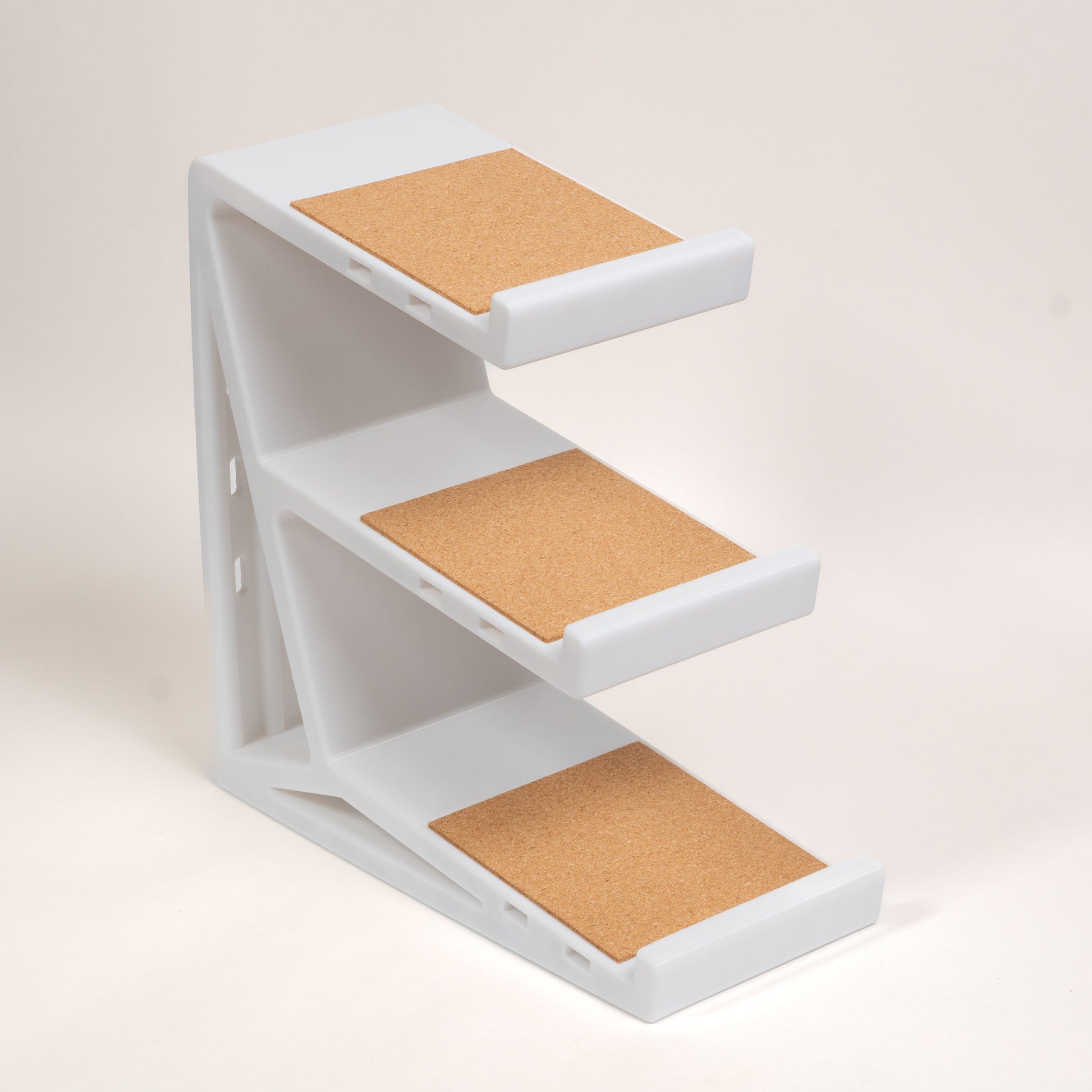 White 3-tier Clackify keyboard stand, empty, showing three cork-lined shelves
