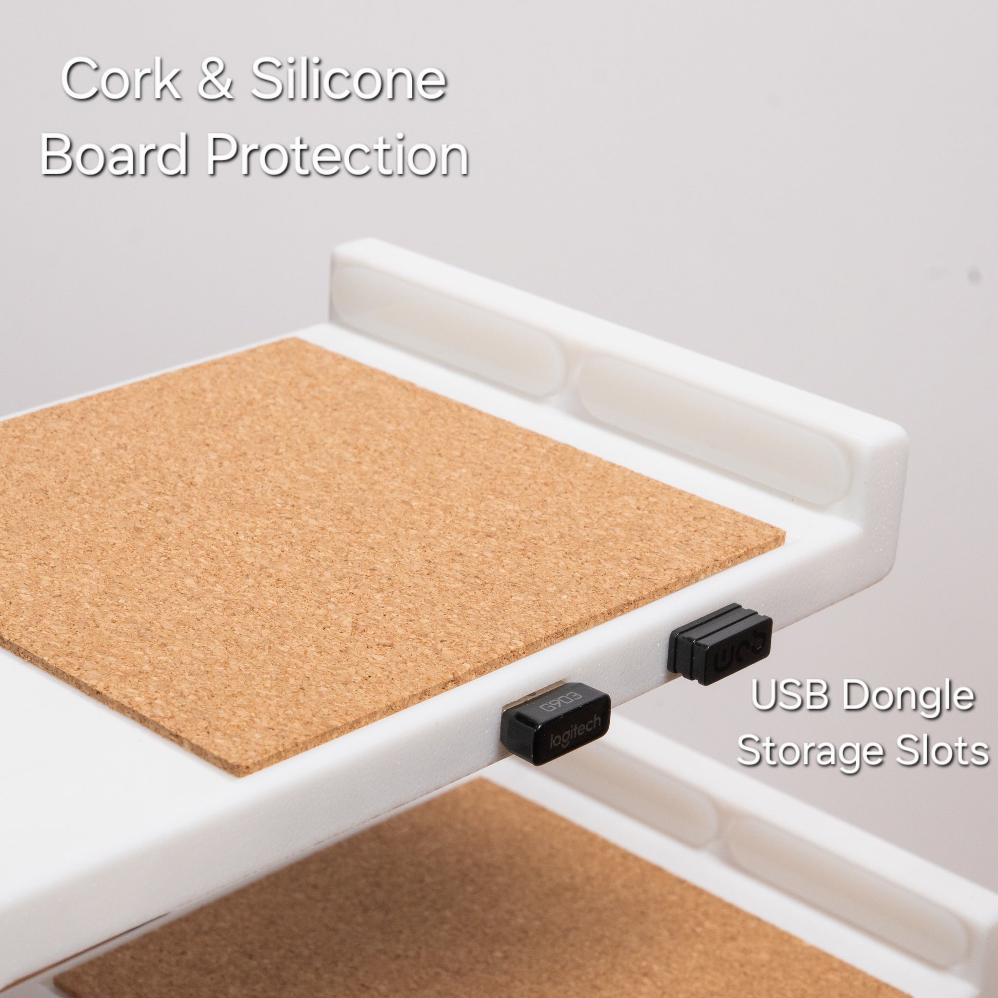 Close-up of a cork-lined shelf with two USB dongles seated in the built-in storage slots